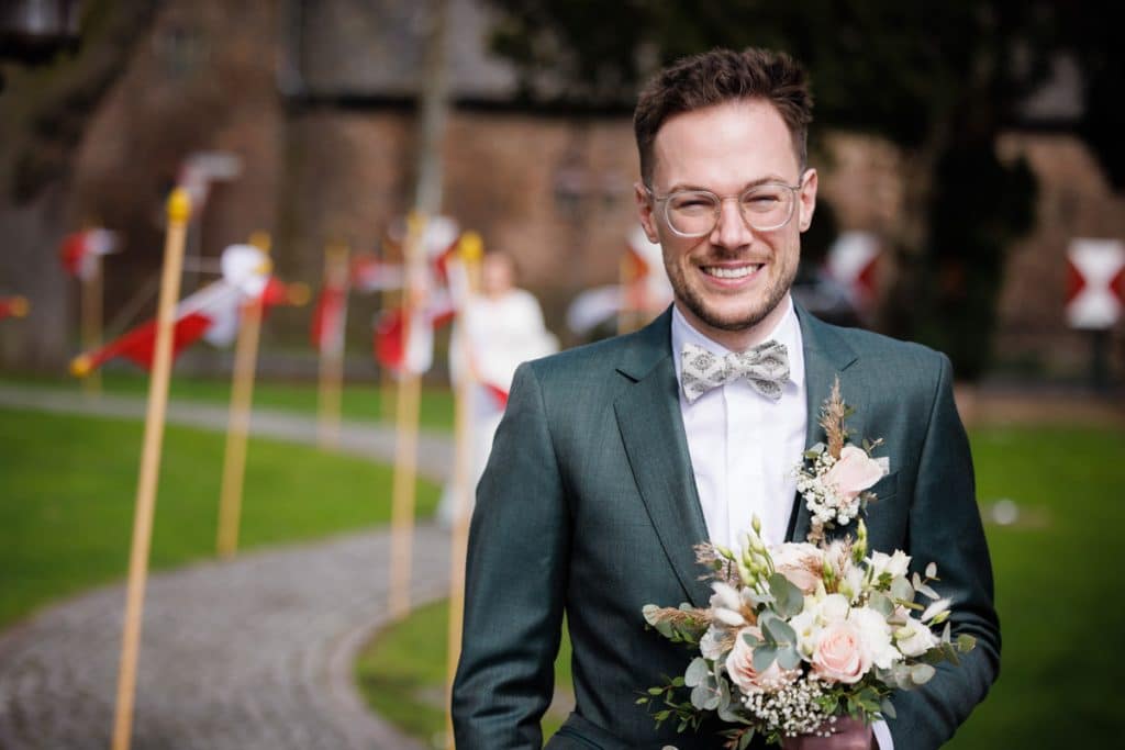 First Look. Ein Brautpaar in Wesel trifft sich zum ersten Mal vor der kirchlichen Trauung, festgehalten von einem Hochzeitsfotografen in Wesel
