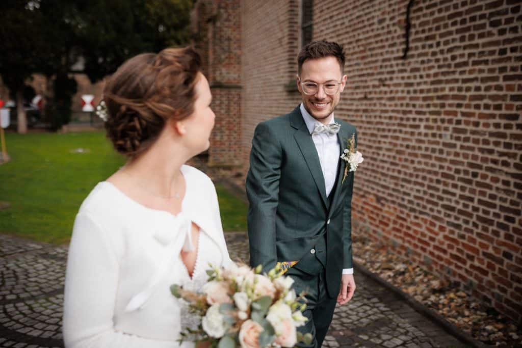First Look. Ein Brautpaar in Wesel trifft sich zum ersten Mal vor der kirchlichen Trauung, festgehalten von einem Hochzeitsfotografen in Wesel