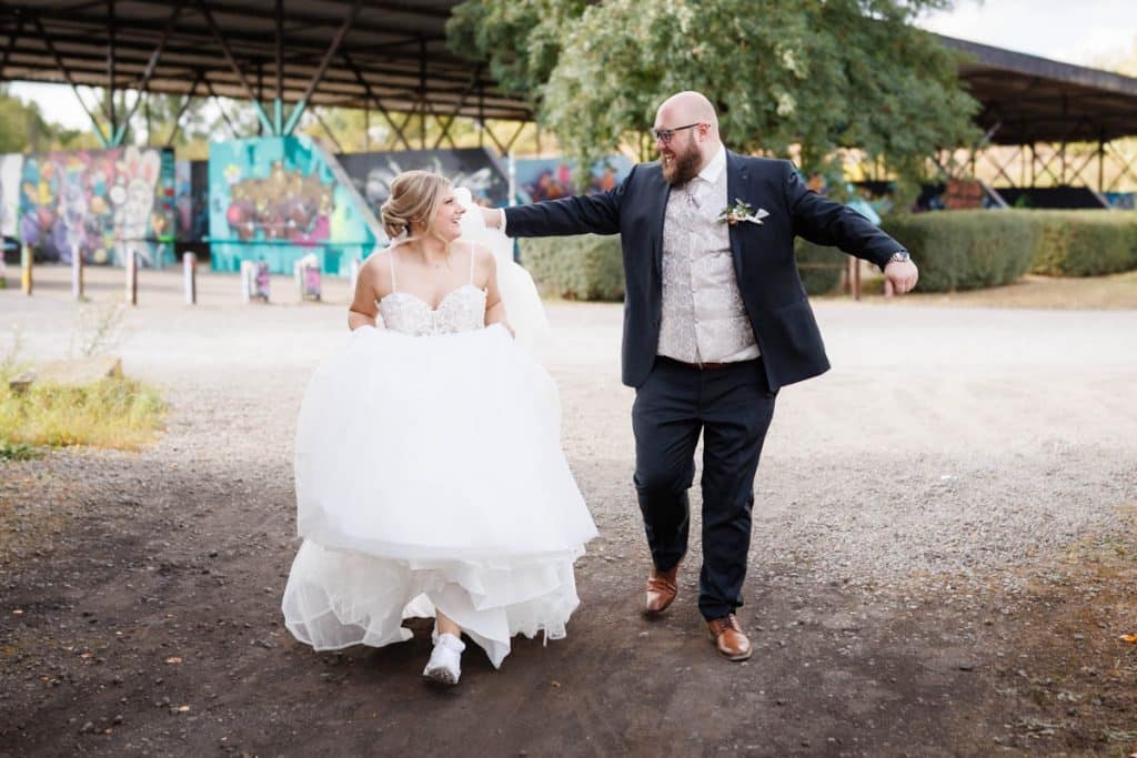 Fotoshooting im Landschaftspark Duisburg Nord: Das Brautpaar posiert in der einzigartigen Industriekulisse zwischen alten Stahlkonstruktionen und grüner Natur. Kreative und emotionale Hochzeitsfotos voller Kontraste, festgehalten vom Hochzeitsfotograf Duisburg.