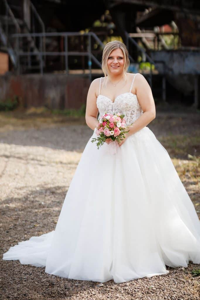 Fotoshooting im Landschaftspark Duisburg Nord: Das Brautpaar posiert in der einzigartigen Industriekulisse zwischen alten Stahlkonstruktionen und grüner Natur. Kreative und emotionale Hochzeitsfotos voller Kontraste, festgehalten vom Hochzeitsfotograf Duisburg.