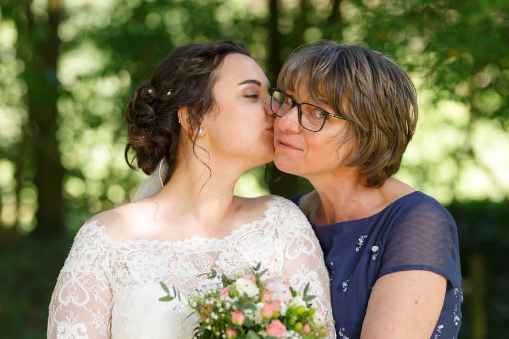 Fröhliche Gruppenfotos nach der Hochzeit in Xanten: Das Brautpaar posiert mit Familie und Freunden vor der Kirche. Lächelnde Gesichter, elegante Outfits und die festliche Stimmung machen die Gruppenfotos zu einer bleibenden Erinnerung. Fotografiert vom Hochzeitsfotograf Xanten.