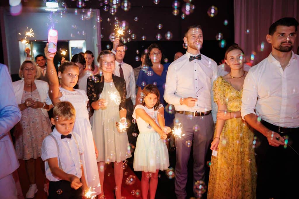 Ausgelassene Hochzeitsfeier im Resonanzwerk Oberhausen: Das Brautpaar eröffnet den Tanz, Gäste feiern ausgelassen auf der Tanzfläche und genießen das festliche Ambiente. Lebendige Reportagebilder voller Emotionen, aufgenommen vom Hochzeitsfotograf Duisburg.