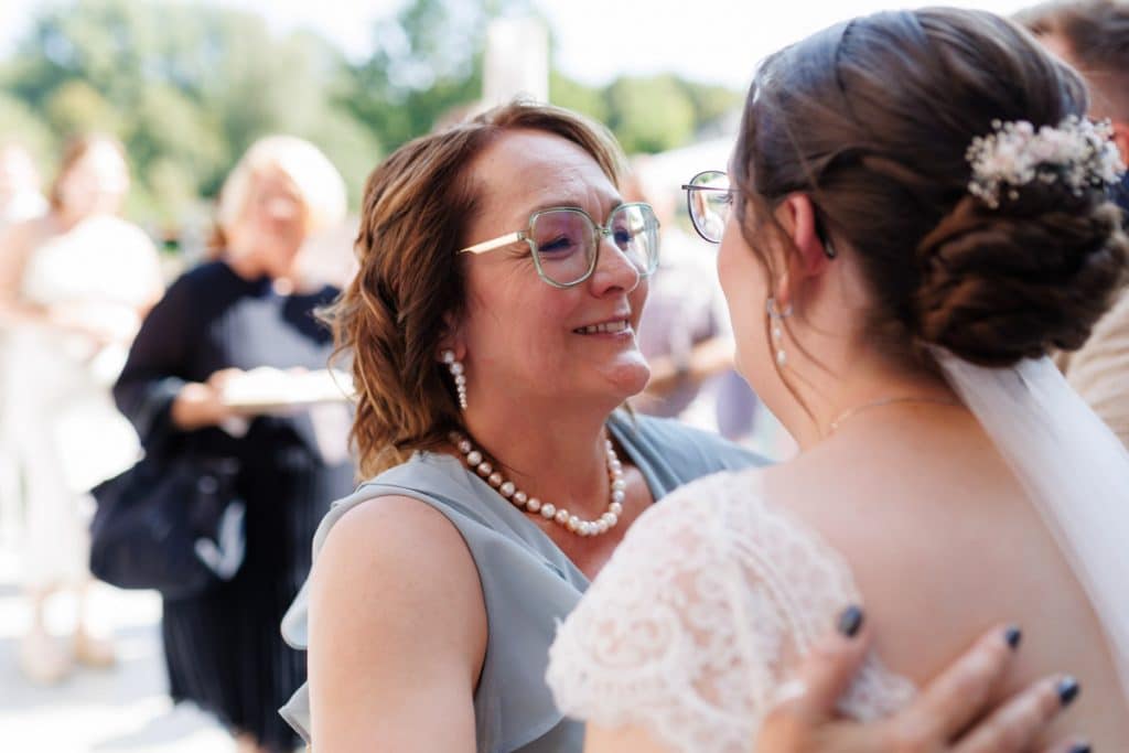 Feierliche Momente nach der Trauung im Schloss Diersfordt in Wesel: Gäste gratulieren dem Brautpaar herzlich, es entstehen weitere Gruppenfotos und beim Sektempfang wird mit Sekt angestoßen. Der Anschnitt der Hochzeitstorte sorgte für zusätzliche emotionale Bilder. Authentisch festgehalten vom Hochzeitsfotograf Wesel.